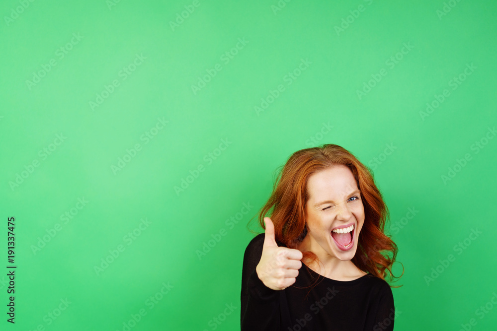 Cheerful woman giving thumb up on green background Cheerful woman giving thumb up on green background