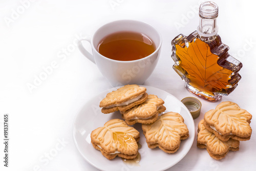 black tea Cup, maple syrup and maple syrup cookies on white background
