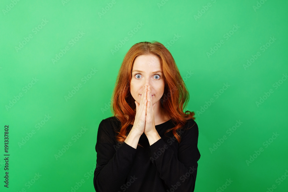 Redhead woman looking in wide eyed astonishment Redhead woman looking in wide eyed astonishment