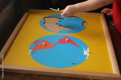 toddler adding europe to continents puzzle