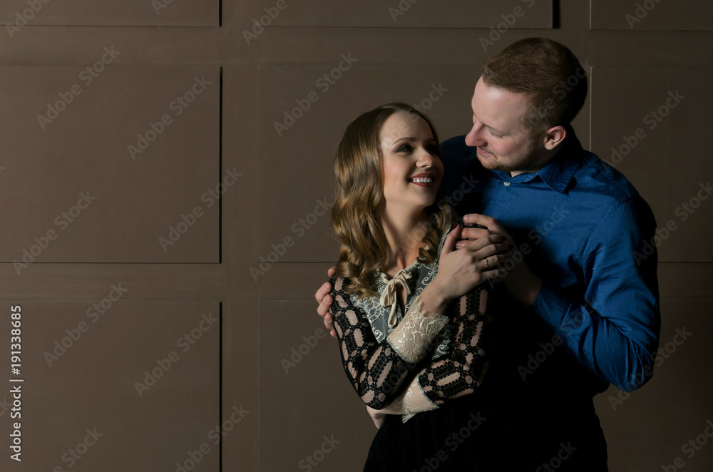 Gentle quivering young couple stands in an embrace - obrazy, fototapety, plakaty 