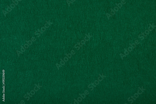 Fragment of the surface of fibrous synthetic non-woven material of light green color. Background, texture