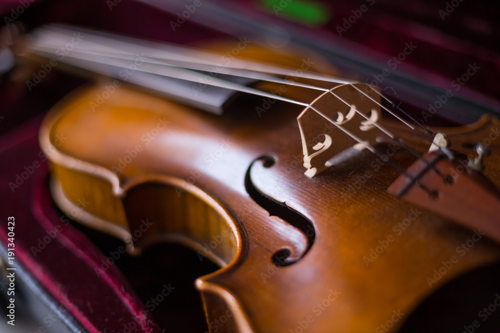 Fototapeta Violin and bow in dark red case.
