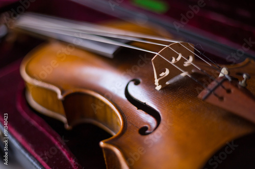 Violin and bow in dark red case. photo