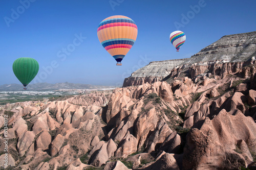 Colorful hot air balloons flying over the Red valley in Cappadocia, Anatolia, Turkey