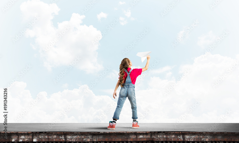 Concept of careless happy childhood with girl dreaming to become pilot Concept of careless happy childhood with girl dreaming to become pilot