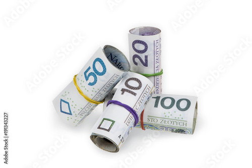 Pile of rolls of polish zloty banknotes of various denominations tied with rubber bands isolated on white background with clipping path.