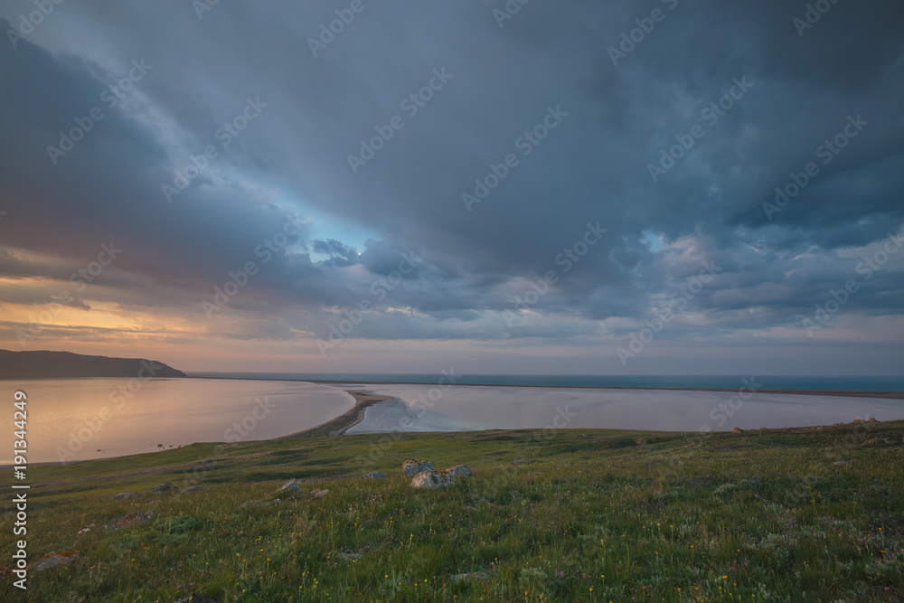 Fototapeta premium The movement of clouds in the spring in the steppe part of the Crimea peninsula at Cape Opuk.