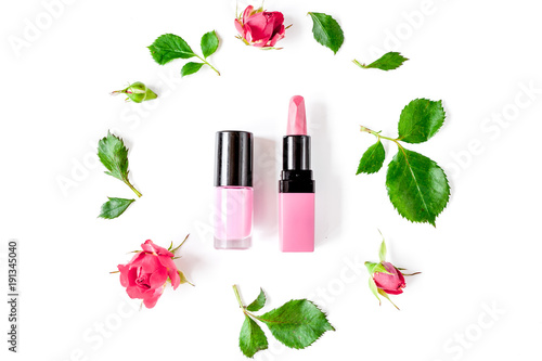berry color decorative cosmetics with roses white background top