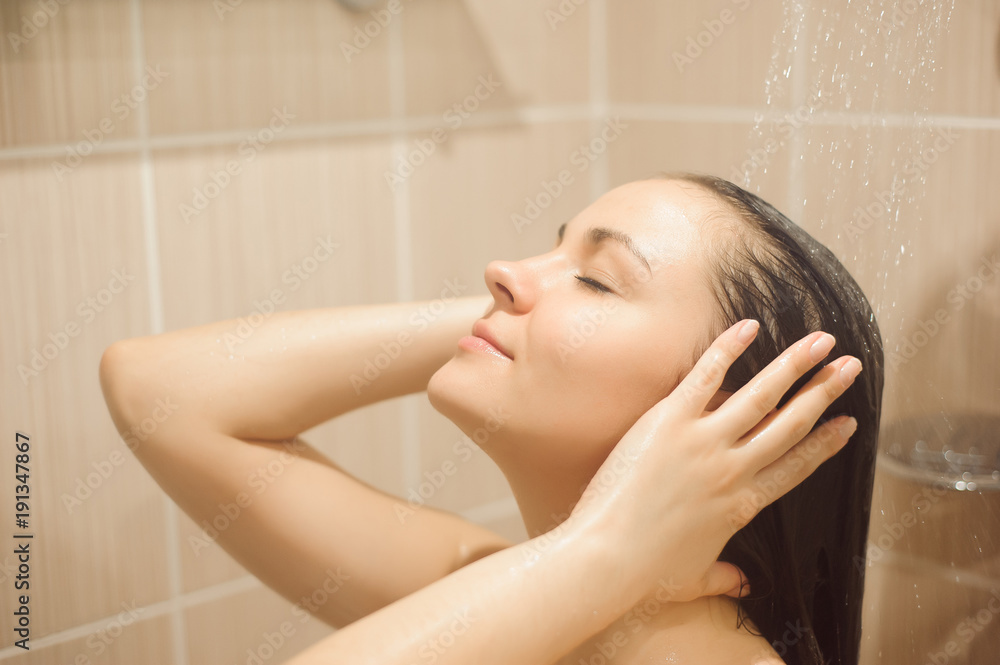Woman with long hair taking shower. Woman with long hair taking shower.