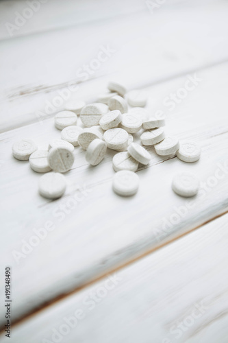 Animal pet care. Vitamins pills for pets on white board background, close up, top view. Pet care and veterinary concept