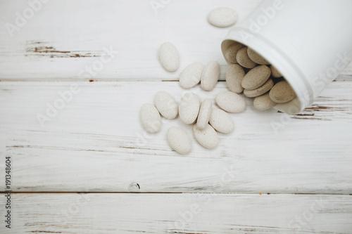 Animal pet care. Vitamins pills for pets on white board background, close up, top view. Pet care and veterinary concept