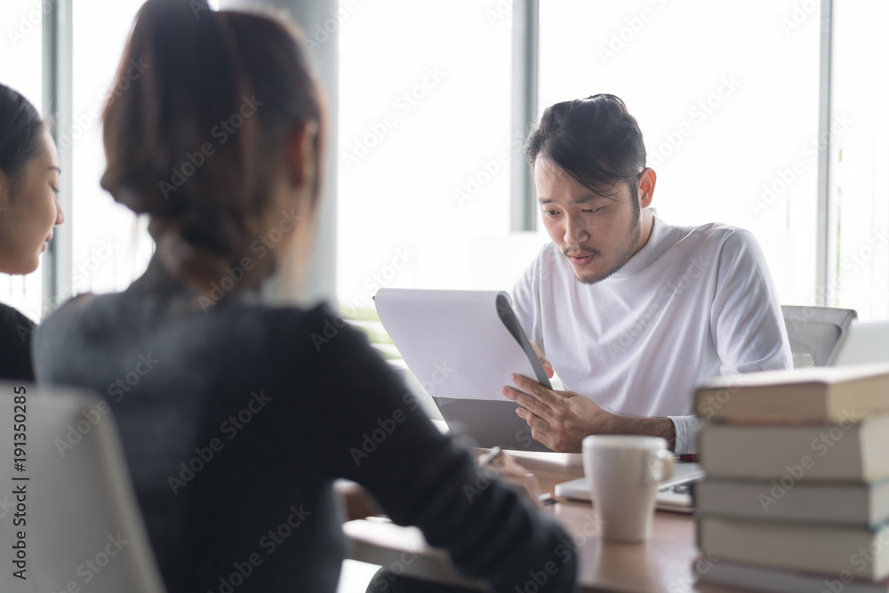 Smiling businessman during job interview.Job interview concept.Businessman explaining and listen to candidate answers. Smiling businessman during job interview.Job interview concept.Businessman explaining and listen to candidate answers.