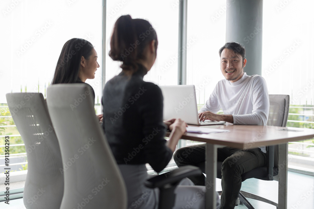 Smiling businessman during job interview.Job interview concept.Businessman explaining and listen to candidate answers. Smiling businessman during job interview.Job interview concept.Businessman explaining and listen to candidate answers.