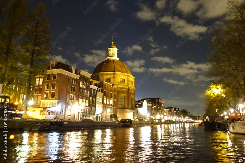 Ronde Lutherse Kerk next to Singel canal in Amsterdam at night