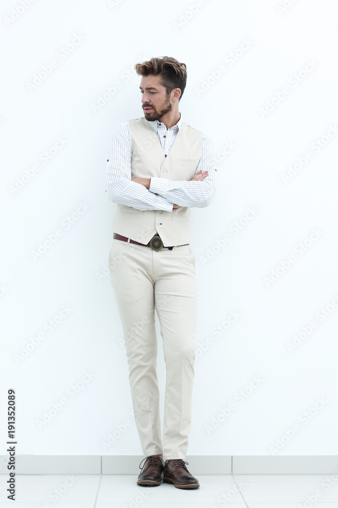 Full length portrait of stylish man with crossed hands
