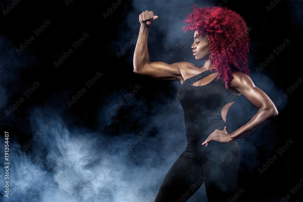 Sporty beautiful afro-american model, woman in sportwear makes fitness exercising at black background to stay fit