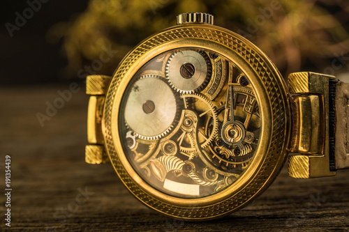 Close up mechanical part of golden vintage watch
