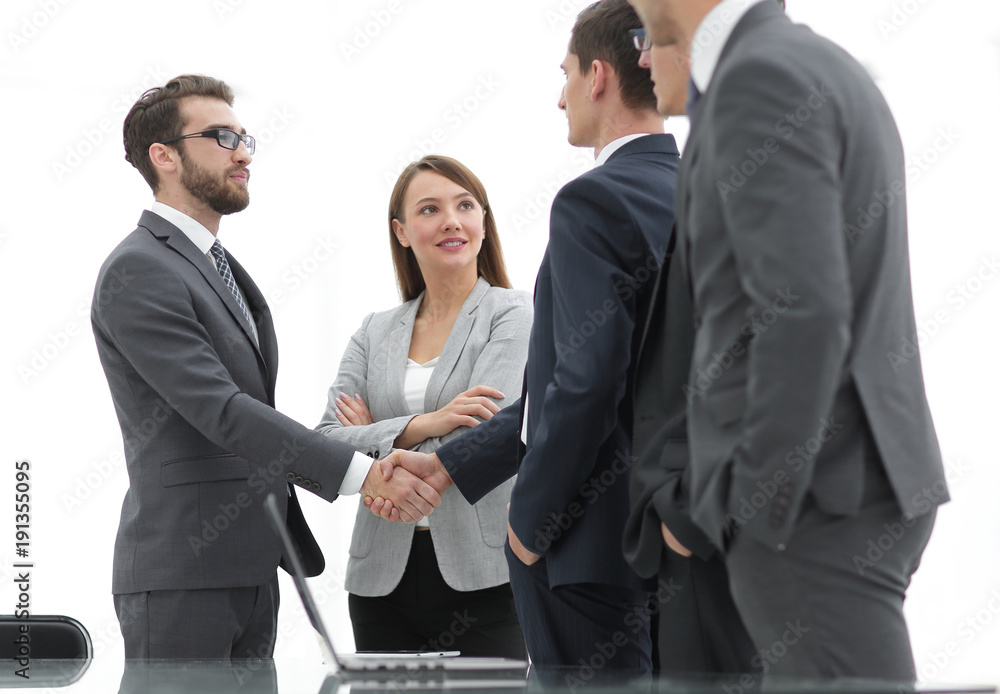 Successful business people shaking hands in an office. Successful business people shaking hands in an office.