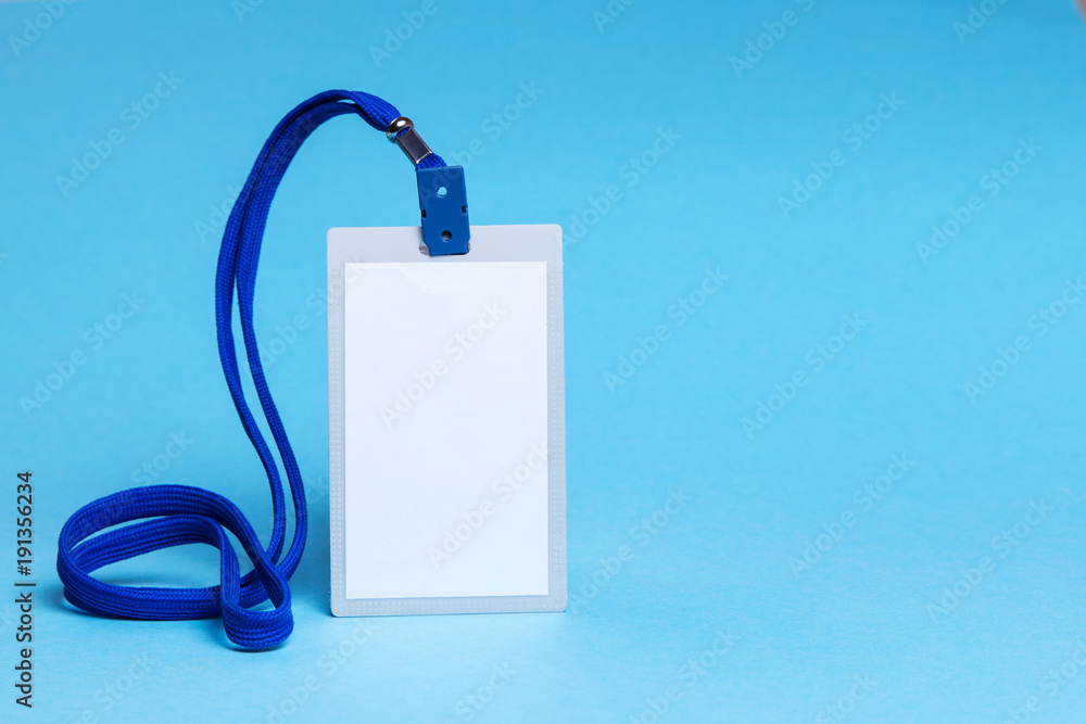 ID card badge with blue ribbon and on a blue background. mock-up. Copy space for text ID card badge with blue ribbon and on a blue background. mock-up. Copy space for text