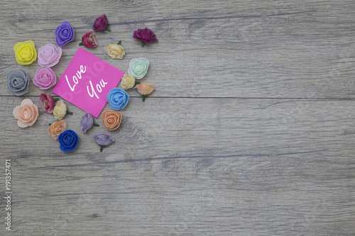 2018 valentines day decor. Group of flowers on wooden table. Lover s day concept with text on sticker  LOVE YOU