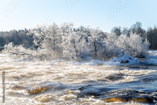 Sunrise river in a cold winter landscape with snow and frost. © Conny Sjostrom