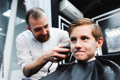 cute young boy getting a haircut