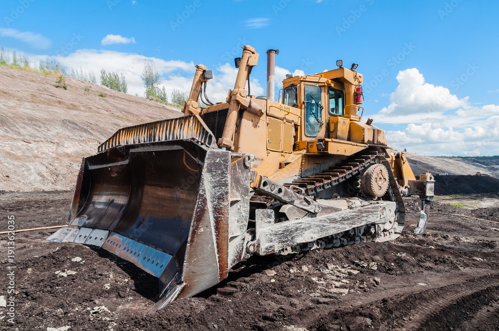Mining Equipment or Mining Machinery, Bulldozer, wheel loader, shovels, loading of coal, ore on the dump truck from open-pit or open-cast mine as the Coal Production. Mining Equipment or Mining Machinery, Bulldozer, wheel loader, shovels, loading of coal, ore on the dump truck from open-pit or open-cast mine as the Coal Production.