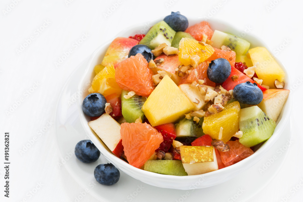 Delicious fruit salad on white table, closeup top view Delicious fruit salad on white table, closeup top view