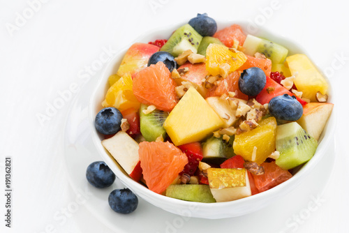 Delicious fruit salad on white table, closeup top view