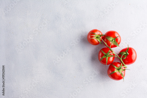 Fresh tomatoes on light concrete background. Flat lay, top view