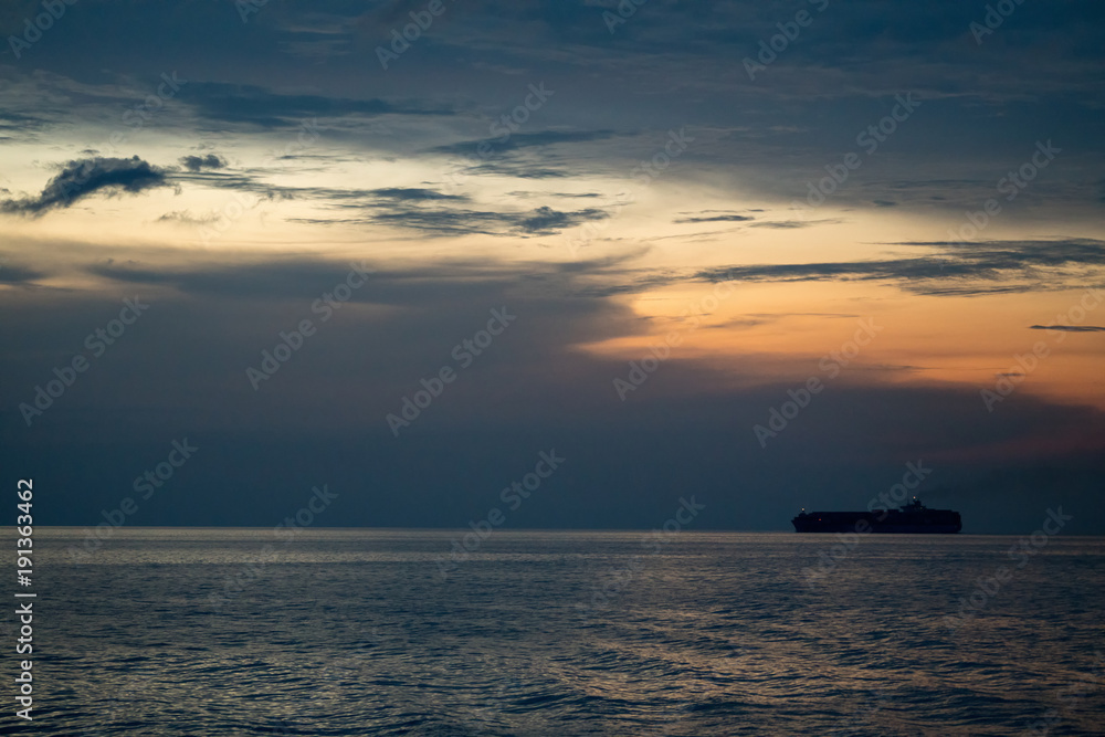 Container ship sail along the trade route in the evening before sunset Container ship sail along the trade route in the evening before sunset