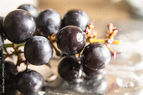 washing black ripe grapes