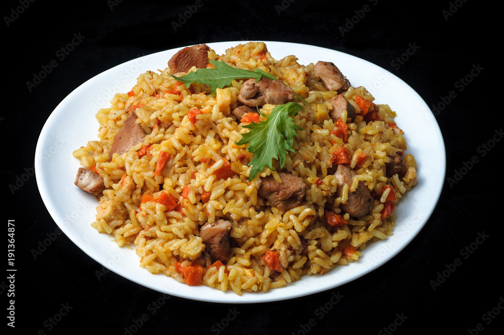 meat with rice and vegetables in white plate isolated on black meat with rice and vegetables in white plate isolated on black