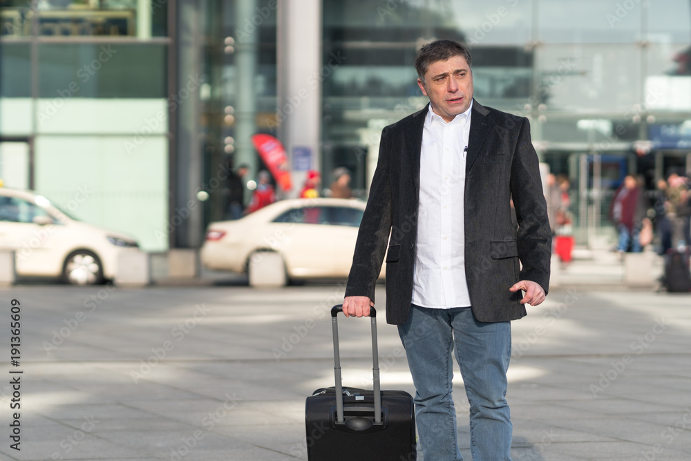 Portrait of traveler with his luggage. Outdoors Portrait of traveler with his luggage. Outdoors