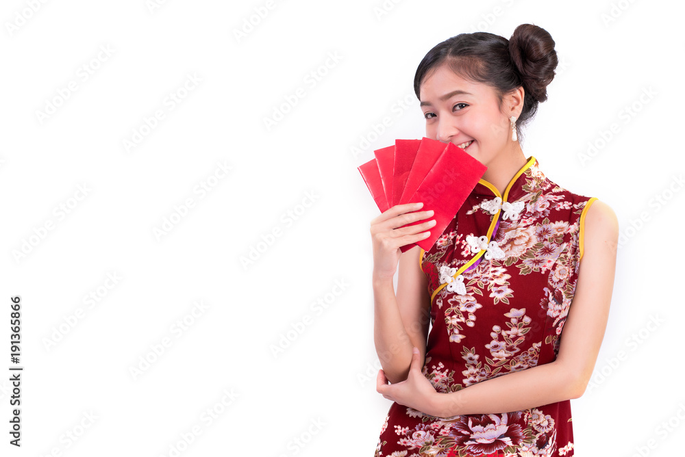 Young Asian beauty woman wearing cheongsam and holding packet of moneys gesture in Chinese new year festival event on isolated white background. Holiday and Lifestyle concept. Qipao dress wearing Young Asian beauty woman wearing cheongsam and holding packet of moneys gesture in Chinese new year festival event on isolated white background. Holiday and Lifestyle concept. Qipao dress wearing