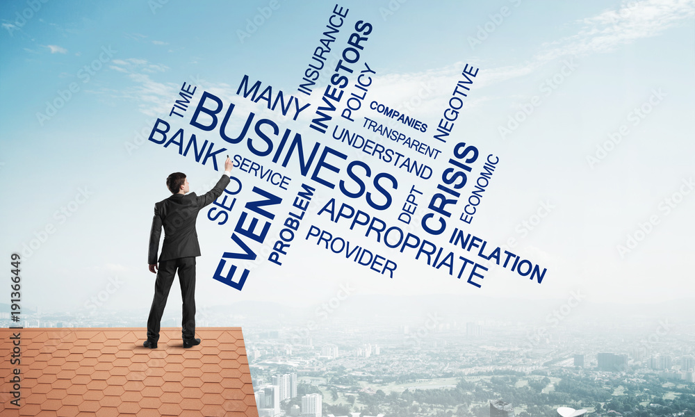 Young businessman standing on house roof and writing leadership skill concept. Mixed media Young businessman standing on house roof and writing leadership skill concept. Mixed media
