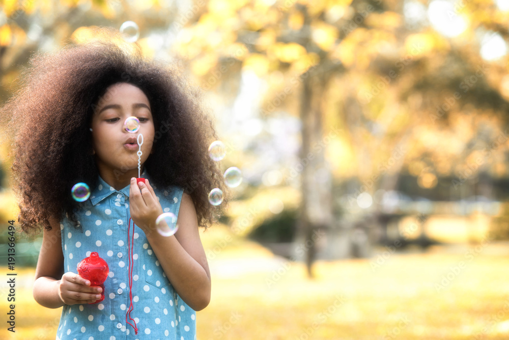 Children are happy to play blow soap bubbles in the garden. Soft focus concept. Children are happy to play blow soap bubbles in the garden. Soft focus concept.