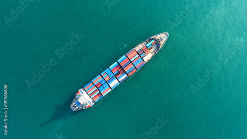 Container ship in export and import business and logistics. Shipping cargo to harbor by crane. Water transport International. Aerial view