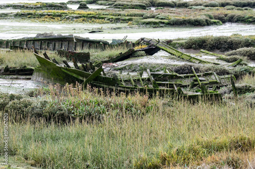 Rotting decay wooden boat hull in estuary mud