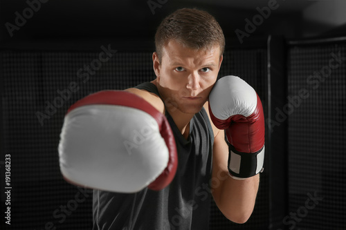 Portrait of young handsome boxer in gym © Africa Studio