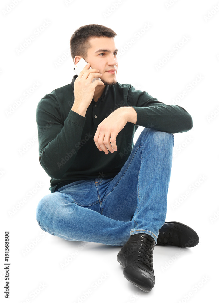 Young man talking on cell phone against white background Young man talking on cell phone against white background