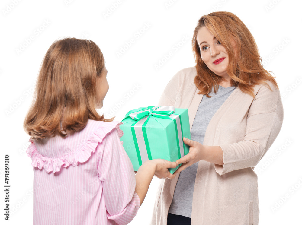 Cute little girl giving her mother present on white background Cute little girl giving her mother present on white background