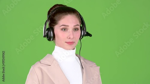 Support worker speaks to customers on the headset. Green screen. Slow motion photo