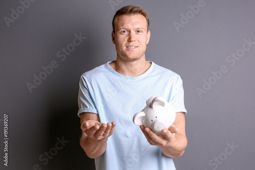 Young man with broken piggy...