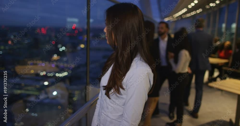 4k, Portrait of a young Asian businesswoman looking at the city at night. Slow motion. 4k, Portrait of a young Asian businesswoman looking at the city at night. Slow motion.
