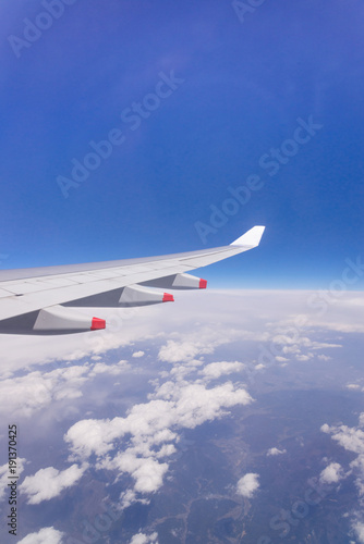 clouds sky skyscape and Wing of airplane with skyline top view. view from the window of an airplane flying in the clouds, sky background