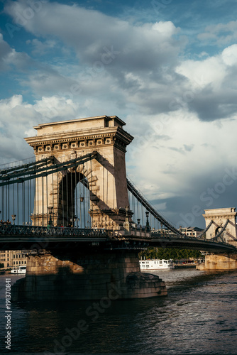 Photography Cloudy sky of the old Chain Bridge on Danube River in Budapest, Hungary