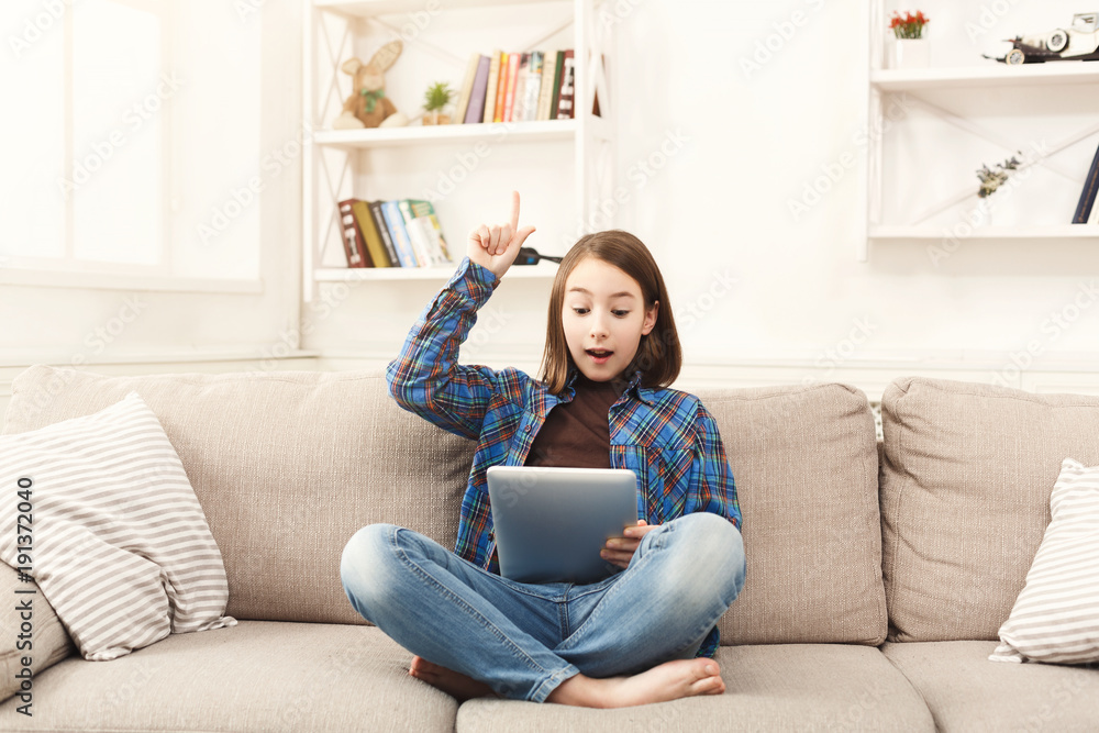 Young happy girl with digital tablet at home Young happy girl with digital tablet at home