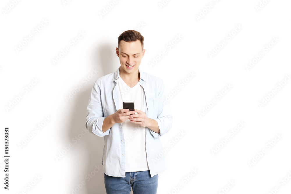 Young man checking mobile phone, reading a message. Technology & relationship concept. Modern romance troubles. Male & female online dating app. Touch screen, chatting, swiping, browsing, surfing. Young man checking mobile phone, reading a message. Technology & relationship concept. Modern romance troubles. Male & female online dating app. Touch screen, chatting, swiping, browsing, surfing.